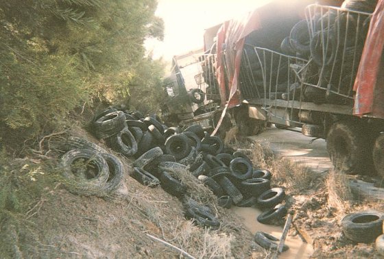 Rubber tyres thrown on the ground after a curtain sider met with an accident