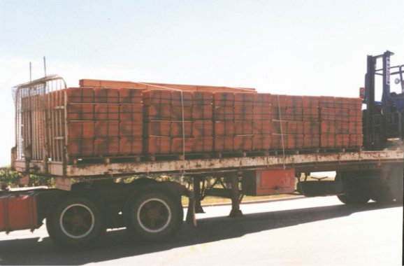 Side view of a trailer loaded with tiles and restrained by two ropes only