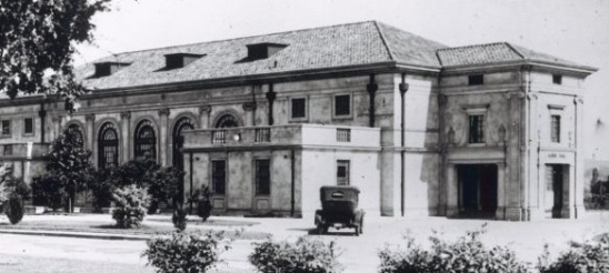 A large building with a car parked in front.