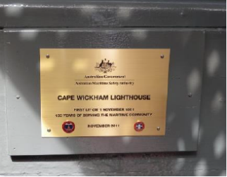 Photograph showing plaque with the Australian Government emblem. Plaque reads: Cape Wickham Lighthouse. First lit on 1 November 1861. 