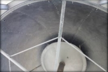 Photograph showing metallic, black inside of dome roof.