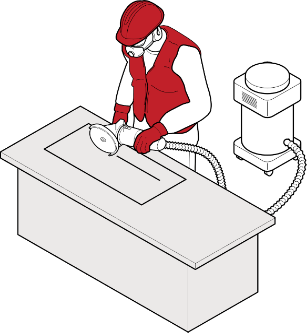 A worker cutting/grinding at a work bench using on tool dust extraction.