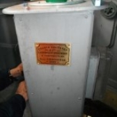 Photograph showing grey pedestal with Chance Brothers plaque fitted on side. 
