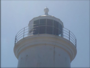 Photograph of white lighthouse lantern room and balcony.