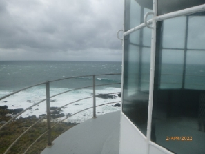 Photograph of lighthouse balcony wrapping around lantern house.