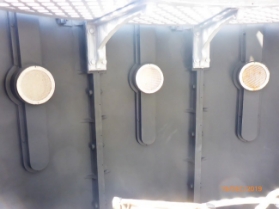 Photograph of internal lantern room with round vents fitted into wall panels.