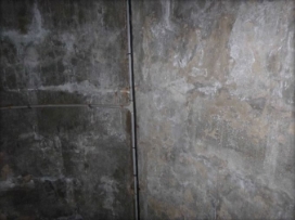 Photograph of internal wall of lighthouse tower. Cabling runs down length of the wall.