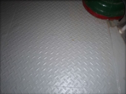 Photograph of section of steel chequer plate floor.