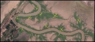 A satellite image of a muddy brown tidal river with mangrove-lined feeder creeks surrounded by bare mud. There are nine hand-drawn yellow crosses on the image.