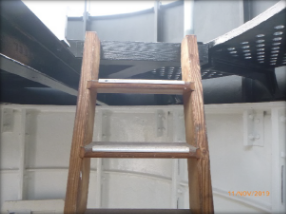 Photograph showing wooden ladder fitted to lantern room hatch.