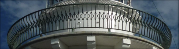 Photograph showing lighthouse balcony with curved gunmetal railing fixed to outer edge of granite floor.