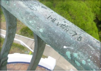 Photograph showing close up of balcony railing. Engraved in the railing is "18 VR 75"