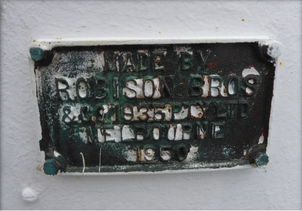 Photograph showing lantern house door plaque which reads "Made by Robison Bros & Co. 1935 Pty Ltd Melbourne 1950".