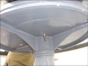 Photograph showing underside of circular grey pedestal.