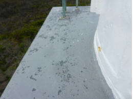 Photograph showing small grey balcony floor.