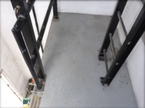Photograph showing narrow mezzanine level with fixed ladder leading to level above.