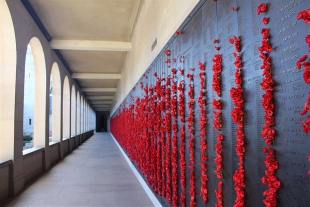 Australian War Memorial, Roll of Honour cloisters with bright red poppies in the brass panels.