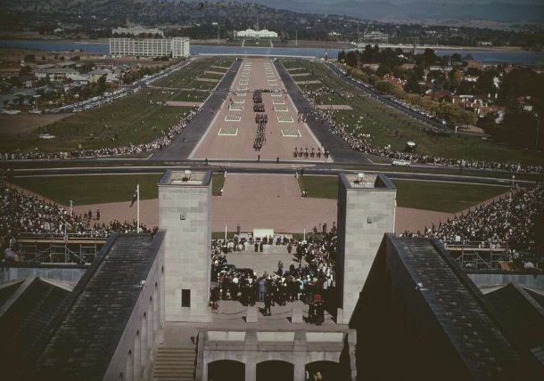 Anzac Day at the Australian War Memorial 1965, large numbers of people. Military personnel marching down the centre of Anzac parade.