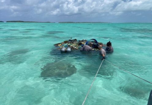 Workers removing marine debris in the southern atoll lagoon