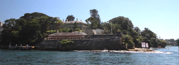Picture shows the house surrounded by a body of water. 