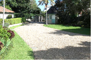 A picture of a gravel driveway and guard house at Kirribilli House