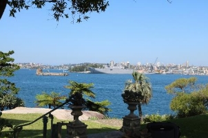 A picture from Kirribilli House overlooking the Sydney Harbour showing the water, trees and buildings across. 