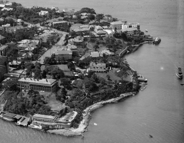 A black and white aerial shot image of Kirribilli and Admiralty house grounds and Kirribilli Point surrounded by a body of water from the Harbour