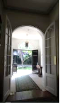 A picture from inside the Kirribilli House entry way with the two white arched doors open
