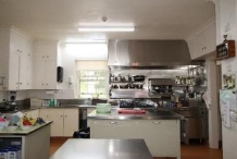 A picture of a kitchen in Kirribilli House predominantly made of steel and with steel appliances