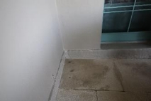 A picture of brown splotches on the ground from damp pavers