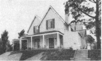A black and white picture of Kirribilli House from the garden showing the property and stairs leading to the lawns surrounded by large trees